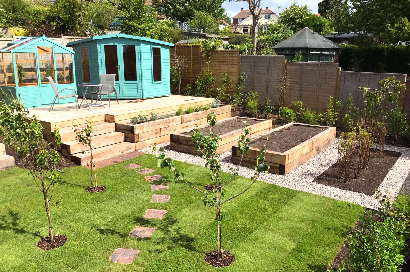 Productive fruit and vegetable garden in Woodingdean, Sussex with oak sleepers and deck.
